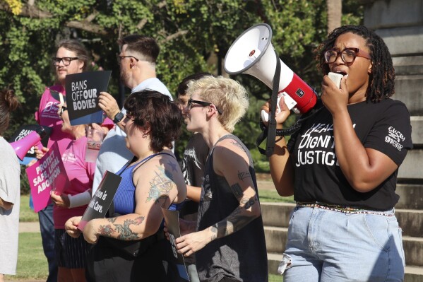 Over two dozen abortion rights supporters attend a rally outside the South Carolina State House in Columbia, .C., on Wednesday, Aug. 23, 2023. The South Carolina Supreme Court ruled Wednesday to uphold a law banning most abortions except in the earliest weeks of pregnancy. (AP Photo/James Pollard)