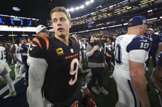 Cincinnati Bengals quarterback Joe Burrow (9) turns after greeting Dallas Cowboys quarterback Cooper Rush (10) after an NFL football game, Monday, Dec. 9, 2024, in Arlington, Texas. (AP Photo/Julio Cortez)