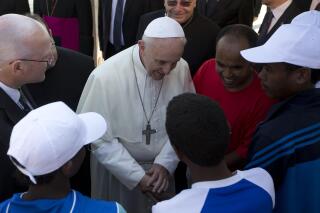 FILE - In this July 8, 2013 file photo, Pope Francis speaks to migrants, some wearing white caps, during his visit to the island of Lampedusa, southern Italy. Pope Francis on Thursday, May 6, 2021 denounced “aggressive” nationalism that rejects migrants and demanded that Catholics follow the Gospel-mandated call for an inclusive, welcoming church that doesn’t distinguish between “natives and foreigners, residents and guests.” (AP Photo/Alessandra Tarantino, pool )