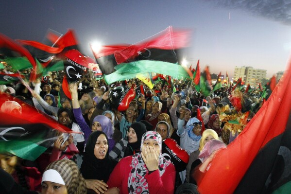 Libyans celebrate the official liberation of Libya after months of bloodshed that culminated in the death of longtime leader Moammar Gadhafi, at Saha Kish Square in Benghazi, Libya, on Oct. 23, 2011. (AP Photo/Francois Mori, File)