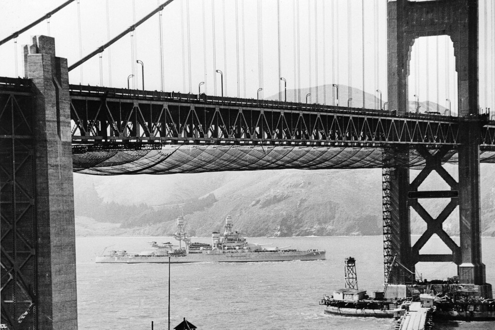 The U.S. Navy joined with San Francisco in celebration of the opening of the Golden Gate Bridge.  A naval vessel had just passed under the world's longest suspension span, which crosses the famed entrance to San Francisco Bay.  (AP Photo)