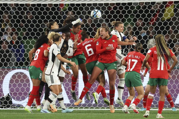 Morocco's goalkeeper Khadija Er-Rmichi tries to punch the ball away as players collide in front of the Moroccan net, leading to an own goal, during the Women's World Cup Group H soccer match between Germany and Morocco in Melbourne, Australia, Monday, July 24, 2023. (AP Photo/Victoria Adkins)