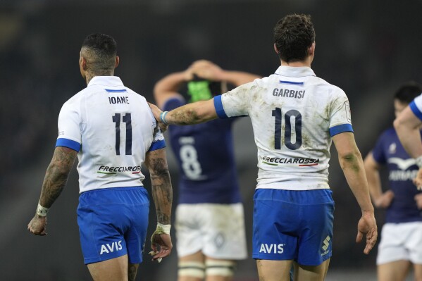 Italy's Paolo Garbisi and Italy's Montanna Ioane stand on the pitch during the Six Nations rugby union international between France and Italy at the Pierre Mauroy stadium in Villeneuve d'Ascq, northern France, Sunday, Feb. 25, 2024. (AP Photo/Lewis Joly)