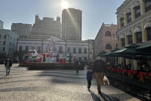 Tourist spot Senado Square remains quiet even after the easing of COVID entry restrictions in Macao on Dec. 28, 2022. Only a few tourists crisscrossed the wavy black and white paving of Macao's historic Senado Square on a recent weekday and many of the shops were shuttered. (AP Photo/Kanis Leung)