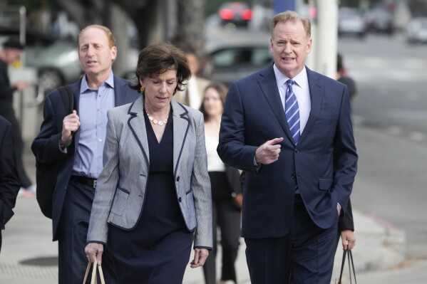 NFL Commissioner Roger Goodell, right, arrives at federal court Monday, June 17, 2024, in Los Angeles. Goodell is expected to testify as a class-action lawsuit filed by "Sunday Ticket" subscribers claiming the NFL broke antitrust laws. (AP Photo/Damian Dovarganes)