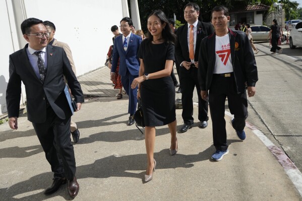 Move Forward Party's Chonthicha Jangrew, center, arrives at the Thanyaburi Provincial Court in Pathum Thani province, north of Bangkok, Thailand, Monday, May 27, 2024. The Thai court on Monday sentenced the lawmaker from the progressive opposition party to two years in prison after finding her guilty of defaming the monarchy in a speech she made during a protest rally three years ago. (AP Photo/Sakchai Lalit)