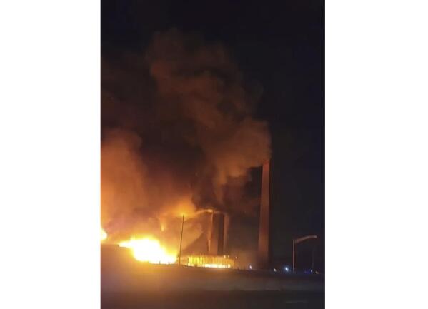 This image from video provided by Mikey B shows a fire near a New Jersey chemical plant, Friday, Jan. 14, 2022 in Passaic, N.J. A fire at a New Jersey chemical plant with flames and smoke visible for miles in the night sky Friday has spread to multiple buildings, threatening to reach the plant's chemical storage area, authorities said.(Mikey B via AP)
