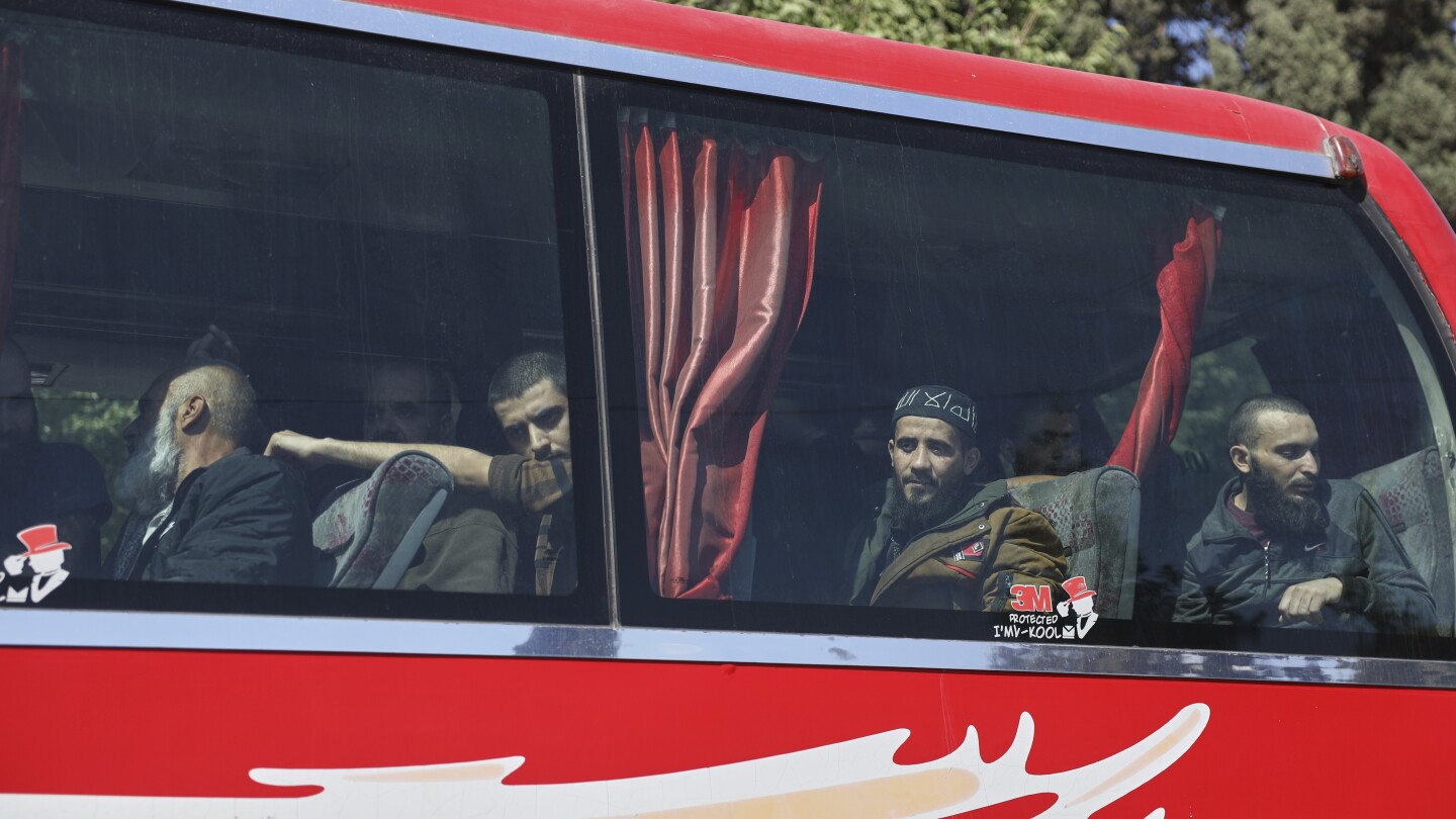Syrian government and Kurdish-led force exchange prisoners in a step toward easing tensions