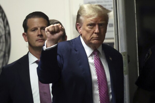 Former President Donald Trump gestures as he returns to the courtroom following a lunch break in his trial, Friday, April 19, 2024, at Manhattan Criminal Court in New York. (Spencer Platt/Pool Photo via AP)