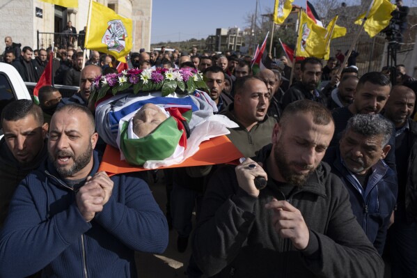 Mourners carry the body of Omar Assad, during his funeral in the West Bank village of Jiljiliya, north of Ramallah, Thursday, Jan. 13, 2022. (AP Photo/Nasser Nasser, File)