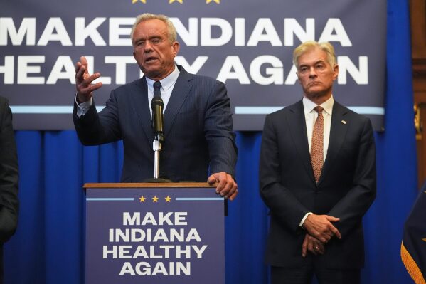 U.S. Health and Human Services Secretary Robert F. Kennedy, Jr speaks as Centers for Medicare and Medicaid Services Administrator Dr. Mehmet Oz listens during a Make Indiana Healthy Again initiative event in Indianapolis, Tuesday, April 15, 2025. (AP Photo/Michael Conroy)