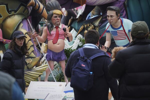 Cardboard sculptures known as "Ninots" depicting U.S. President Donald Trump and Elon Musk, right, are displayed during the Fallas festival in Valencia, Spain, on Wednesday, March 19, 2025.  (AP Photo/Alberto Saiz)