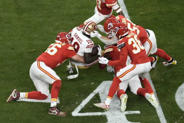 San Francisco 49ers wide receiver Deebo Samuel (19) is tackled by the Kansas City Chiefs during the first half of the NFL Super Bowl 58 football game Sunday, Feb. 11, 2024, in Las Vegas. (AP Photo/Charlie Riedel)