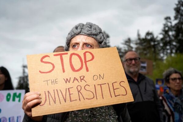 University of California, Berkeley alumna Bethany Schoenfeld demonstrates against the Trump administration at her alma mater as part of a Day of Action for Higher Ed on Thursday, April 17, 2025, in Berkeley, Calif. (AP Photo/Noah Berger)