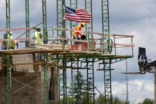 FILE - In this June 11, 2020 file photo, workers on scaffolding lay blocks on one of the larger buildings at a development site where various residential units and commercial sites are under construction in Cranberry Township, Butler County, Pa. U.S. productivity increased at a solid 4.6% pace in the July-September quarter, slightly below the initial estimate, while labor costs fell at a slower pace. The Labor Department reported that the third quarter increase in productivity was below the first estimate a month ago of a 4.9% increase. (AP Photo/Keith Srakocic, File)