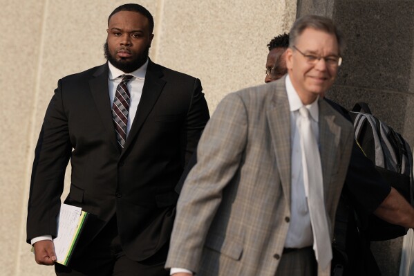 Former Memphis police officer Demetrius Haley, left, leaves the federal courthouse after the first day of jury selection of the trial in the Tyre Nichols case Monday, Sept. 9, 2024, in Memphis, Tenn. (AP Photo/George Walker IV)