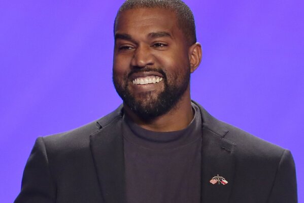 FILE - This Nov. 17, 2019, file photo shows Kanye West on stage during a service at Lakewood Church in Houston. The government's small business lending program has benefited millions of companies, with the goal of minimizing the number of layoffs Americans have suffered in the face of the coronavirus pandemic. Yet the recipients include many you probably wouldn't have expected. West’s clothing-and-sneaker brand Yeezy received a loan of between $2 million and $5 million, according to the data released by Treasury. The company employed 106 people in mid-February before the pandemic struck. (AP Photo/Michael Wyke, File)