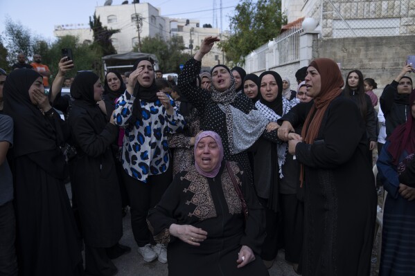 Women cry while they take the last look at the body of Ayham Shafe'e, 14, during his funeral in the West Bank city of Ramallah, Thursday, Nov. 2, 2023. Shafee and a second Palestinian man were killed during an Israeli army raid in Ramallah early morning, the Palestinian Health Ministry said.(AP Photo/Nasser Nasser)