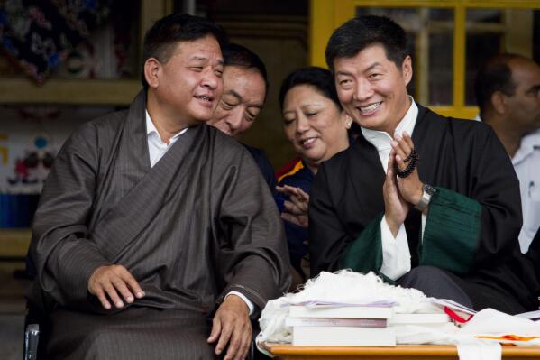 FILE- In this Sept. 2, 2013 file photo, Prime Minister of the Tibetan government-in-exile Lobsang Sangay, right, listens to the Speaker of the Tibetan Parliament Penpa Tsering during the Tibetan Democracy Day celebrations at the Tsuglakhang temple in Dharmsala, India. Penpa Tsering has been elected the new president of the Tibetan government-in-exile, succeeding Lobsang Sangay who is completing two five-year terms each. (AP Photo/Ashwini Bhatia, File)