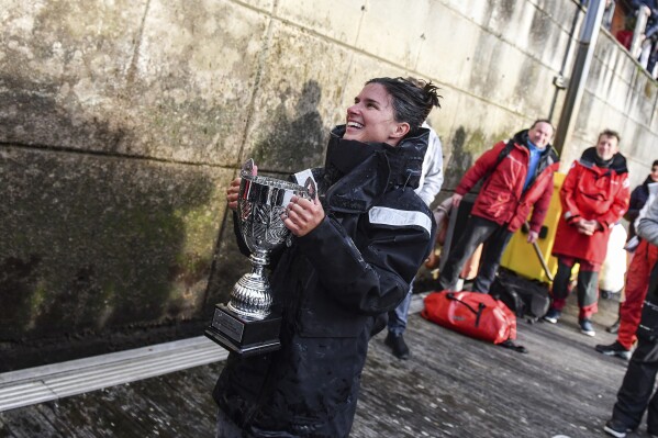 This photo provided by Cole Brauer Ocean Racing shows Brauer as she became the first American woman to race nonstop around the world by herself when she arrived Thursday, March 7, 2024, in A Coruña, Spain. (James Tomlinson/Cole Brauer Ocean Racing via AP)
