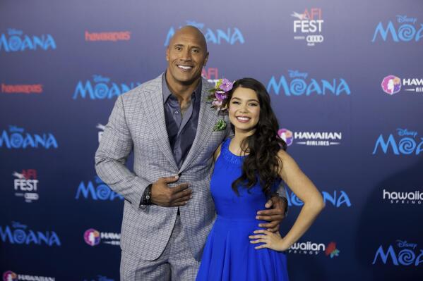 FILE - Actors Dwayne Johnson, left, and Auli'i Cravalho appear at the 2016 AFI Fest - "Moana" world premiere in Los Angeles on Nov. 14, 2016. Disney chief executive Bob Iger on Monday announced that a live-action “Moana” remake is in development in a call with investors. The production is in the early stages, but Dwayne Johnson is set to return as the demigod Maui. Cravalho, who voiced Moana in the original, is to be an executive producer on the live-action version. (Photo by Willy Sanjuan/Invision/AP, File)