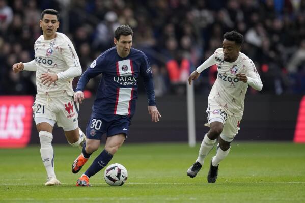 PSG's Lionel Messi, centre, dribbles past Lille's Benjamin Andre, left, and Lille's Timothy Weah during the French League One soccer match between Paris Saint-Germain and Lille at the Parc des Princes stadium, in Paris, France, Sunday, Feb. 19, 2023. (AP Photo/Christophe Ena)