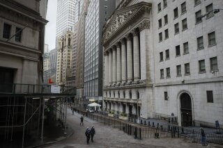 FILE - In a Friday, May 1, 2020 file photo, NYPD officers walk along a sparsely populated Wall Street, in the Manhattan borough of New York. The devastation rocking the economy becomes more clear by the week with reports continually showing how many million workers have lost their jobs due to the coronavirus outbreak. Wall Street sees that pain, but it already sent the U.S. stock market down by a third more than a month ago on anticipation of that. Now, it’s looking further ahead and sees a future that’s not as bad as this horrific present. That’s why stocks just had their best month in a generation. Whether they’re correct is still to be determined. (AP Photo/John Minchillo, File)