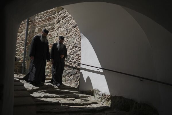 Father Kosmas, left, and Father Nyfmon walk in the Simonopetra, or Simonos Petra Monastery, home of the all-male autonomous community Agion Oros, or Holy Mountain, on the peninsula of Mount Athos in northern Greece, April 13, 2025. (AP Photo/Thanassis Stavrakis)
