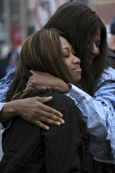 Paris Stevens, cousin of George Floyd, left, embraces Angela Harrelson, Floyd's aunt, at George Floyd Square Wednesday, May 25, 2022, in Minneapolis. The intersection where Floyd died at the hands of Minneapolis police officers was renamed in his honor Wednesday, among a series of events to remember a man whose killing forced America to confront racial injustice. (Aaron Lavinsky/Star Tribune via AP)