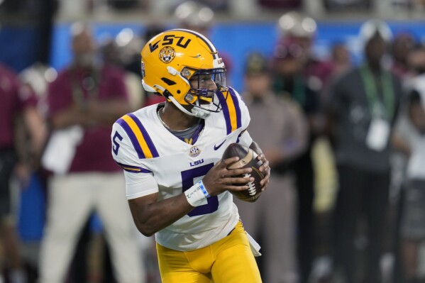 LSU quarterback Jayden Daniels looks for a receiver against Florida State during the first half of an NCAA college football game, Sunday, Sept. 3, 2023, in Orlando, Fla. (AP Photo/John Raoux)