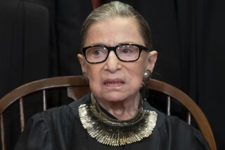 FILE - In this Nov. 30, 2018 file photo, Associate Justice Ruth Bader Ginsburg sits with fellow Supreme Court justices for a group portrait at the Supreme Court Building in Washington. Ginsburg suggested Friday, June 7, 2019, that there will be sharp divisions among her colleagues as they finish their term, with decisions in high-profile cases about the census and the drawing of electoral maps expected before the end of the month. (AP Photo/J. Scott Applewhite, File)