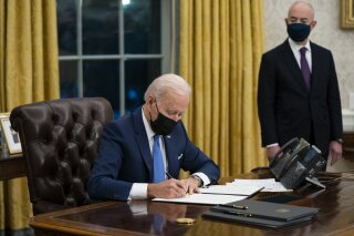 FILE - In this Feb. 2, 2021, file photo, Secretary of Homeland Security Alejandro Mayorkas looks on as President Joe Biden signs an executive order on immigration, in the Oval Office of the White House in Washington.  (AP Photo/Evan Vucci, File)