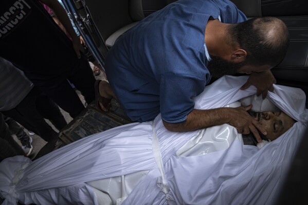 FILE - A relative mourns over a man killed in an Israeli air strike in Gaza City on Monday, Oct. 9, 2023. (AP Photo/Fatima Shbair, File)