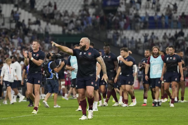 England's Joe Marler, centre, gestures to the crowd as he celebrates with teammates after the end of the Rugby World Cup Pool D match between England and Argentina in the Stade de Marseille, Marseille, France Saturday, Sept. 9, 2023. England won the match 27-10. (AP Photo/Pavel Golovkin)