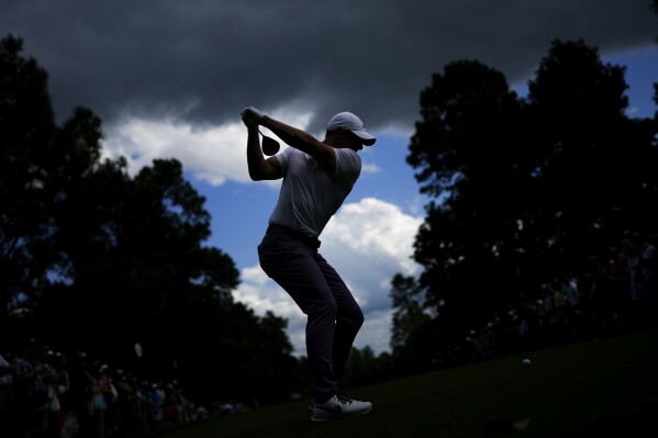 An AP photographer gets in the right spot for a big swing at the Masters
