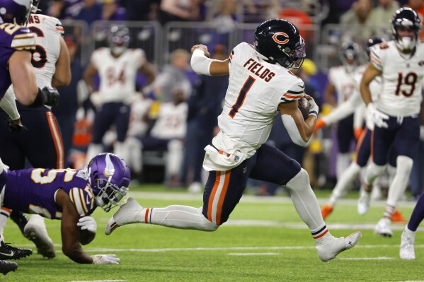 Chicago Bears quarterback Justin Fields (1) runs up field during the second half of an NFL football game against the Minnesota Vikings, Monday, Nov. 27, 2023, in Minneapolis. (AP Photo/Bruce Kluckhohn)