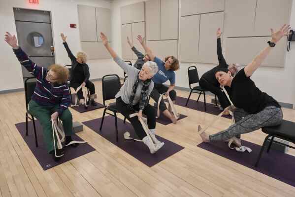 Whitney Chapman, right, conducts a chair yoga class at the Marlene Meyerson JCC Manhattan, in New York, March 28, 2025. (AP Photo/Richard Drew)