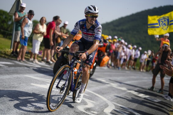 FILE - France's Julian Alaphilippe rides breakaway during the tenth stage of the Tour de France cycling race over 167 kilometers (104 miles) with start in Vulcania and finish in Issoire, France, Tuesday, July 11, 2023. Two-time world road champion Alaphilippe has confirmed he will join the 25th edition of the Tour Down Under in January, ten years after making his world tour debut at Australia's flagship cycling tour.(APPhoto/Thibault Camus, File)