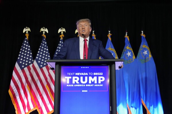 FILE - Former President Donald Trump speaks at a campaign event, July 8, 2023, in Las Vegas. Six Republicans who have been indicted on charges that they submitted paperwork to Congress falsely declaring Donald Trump the winner of the Western swing state in 2020 are scheduled to make their initial court appearances Monday. (AP Photo/John Locher, FIle)