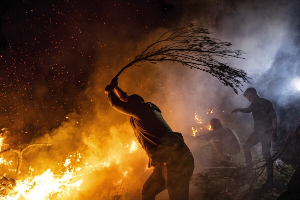 Firefighters and residents try to extinguish a fire in the city of Canakkale, northwest Turkey, Aug. 23, 2023. (Ugur Yildirim/dia images via AP)
