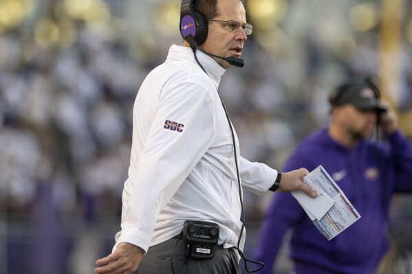 James Madison head coach Curt Cignetti walks onto the field at the start of a timeout during the second half of an NCAA college football game against Connecticut in Harrisonburg, Va., Saturday, Nov. 11, 2023. (Daniel Lin/Daily News-Record via AP)