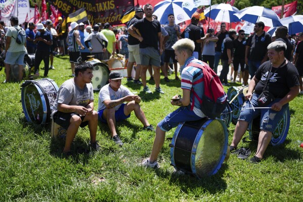 Protesters sit on their drums during a rally at Congress during a national strike against the economic and labor reforms proposed by Argentine President Javier Milei in Buenos Aires, Argentina, Wednesday, Jan. 24, 2024. (AP Photo/Natacha Pisarenko)