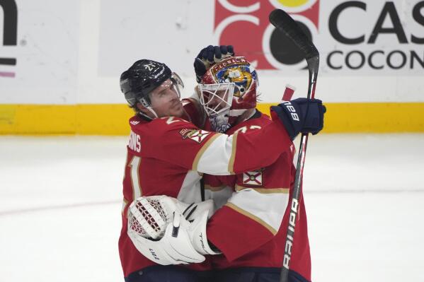 Florida Panthers center Nick Cousins (21) hugs goaltender Sergei Bobrovsky after an NHL hockey game against the Columbus Blue Jackets, Tuesday, Dec. 13, 2022, in Sunrise, Fla. The Panthers won 4-0. (AP Photo/Lynne Sladky)