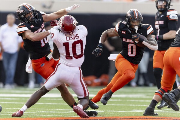 Oklahoma State running back Ollie Gordon II (0) runs the ball past Oklahoma linebacker Kip Lewis (10) in the second half of an NCAA college football game Saturday, Nov. 4, 2023, in Stillwater, Okla. (AP Photo/Mitch Alcala)