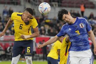 FILE - Ecuador's Byron Castillo, left, and Japan's Shogo Taniguchi challenge for the ball during the international friendly soccer match between Japan and Ecuador as part of the Kirin Challenge Cup in Duesseldorf, Germany, Tuesday, Sept. 27, 2022. (AP Photo/Martin Meissner, File)