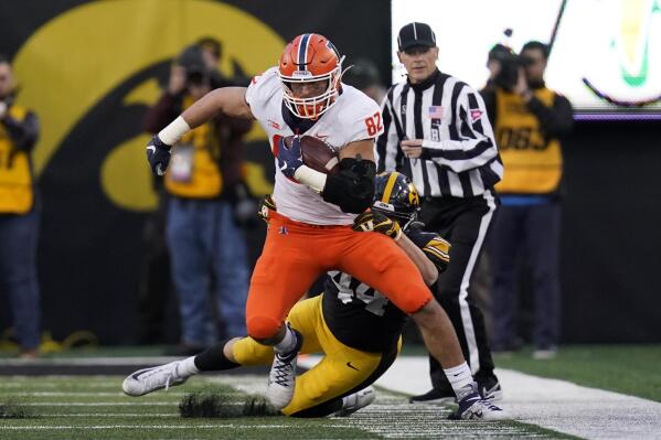 Illinois tight end Luke Ford (82) tries to break a tackle by Iowa linebacker Seth Benson (44) after catching a pass during the second half of an NCAA college football game, Saturday, Nov. 20, 2021, in Iowa City, Iowa. Iowa won 33-23. (AP Photo/Charlie Neibergall)