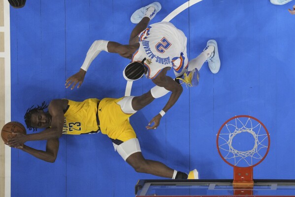 Indiana Pacers forward Aaron Nesmith (23) controls the ball against Oklahoma City Thunder guard Shai Gilgeous-Alexander (2) during the second half of Game 5 of the NBA Finals basketball series, Monday, June 16, 2025, in Oklahoma City. (Kyle Terada/Pool Photo via AP)