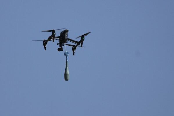 A drone carries a mortar shell as soldiers take part in the U.S.-led Immediate Response 25 military exercise in Petrochori, Greece, Wednesday, June 4, 2025. (AP Photo/Thanassis Stavrakis, File)