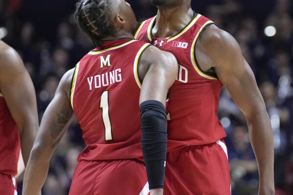 Maryland's Jahmir Young, left, and Jordan Geronimo begin to celebrate the team's 76-67 upset win over Illinois late in the second half of an NCAA college basketball game Sunday, Jan. 14, 2024, in Champaign, Ill. (AP Photo/Charles Rex Arbogast)