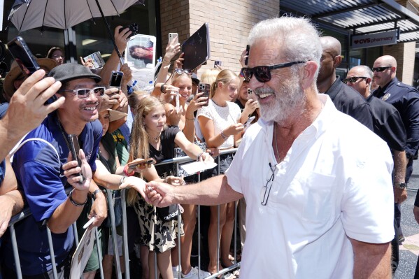 Mel Gibson, right, interacts with crowd members as he leaves a Hollywood Walk of Fame star ceremony for actor Vince Vaughn, on Aug. 12, 2024, in Los Angeles. (AP Photo/Chris Pizzello, File)